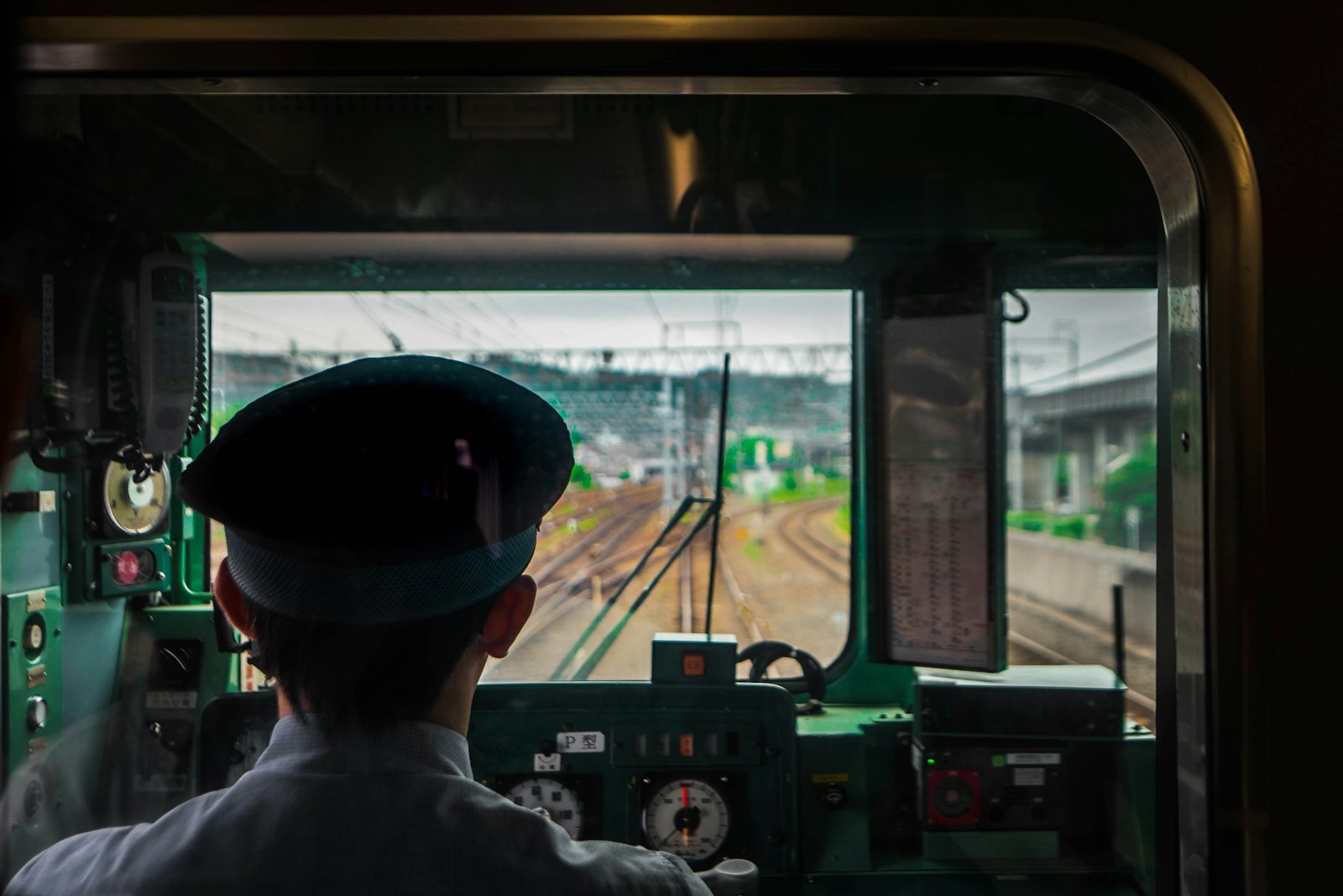 Train driver in the cab looking down the track