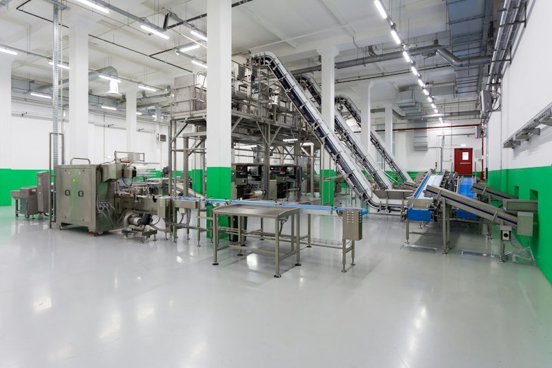Bright food processing hall with stainless steel production lines